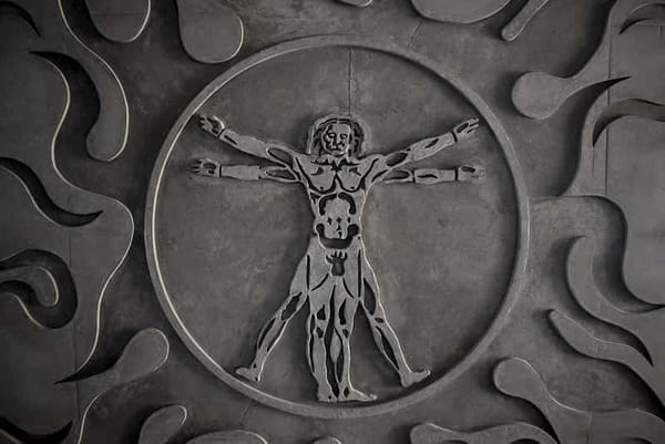 a close-up of a coin depicting an interpretation of Leonardo da Vinci's Vitruvian Man
